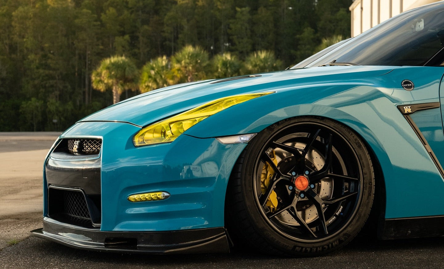 Blue sports car on a track with Corsa Forged Wheels