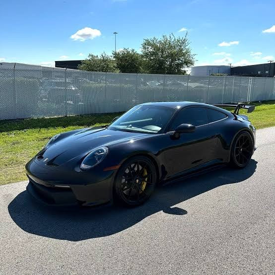 Customer photo of a stock black 992 GT3 on its factory wheels